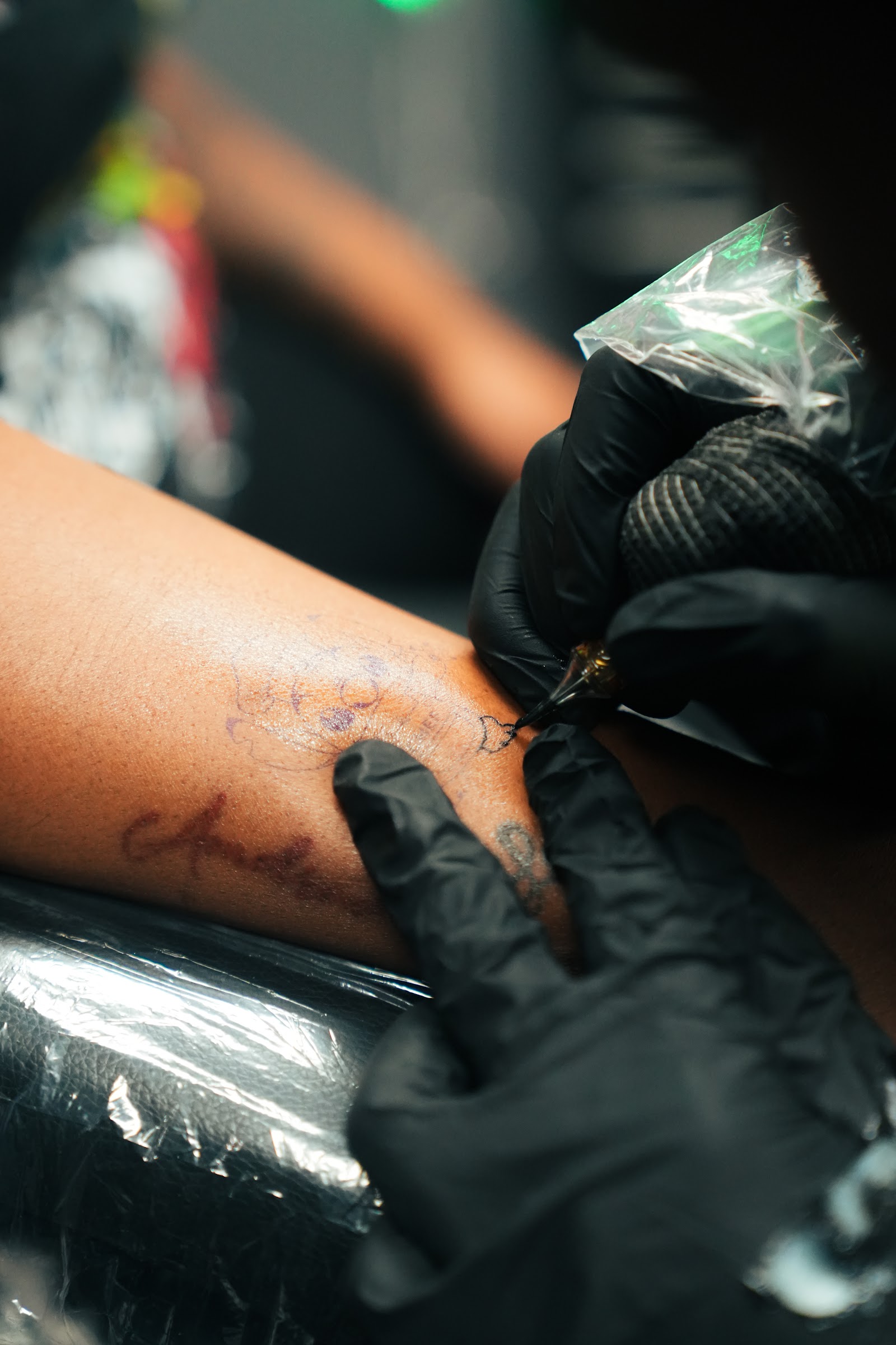 Behind the scenes: script tattoo in progress at OFFWRLD.INK