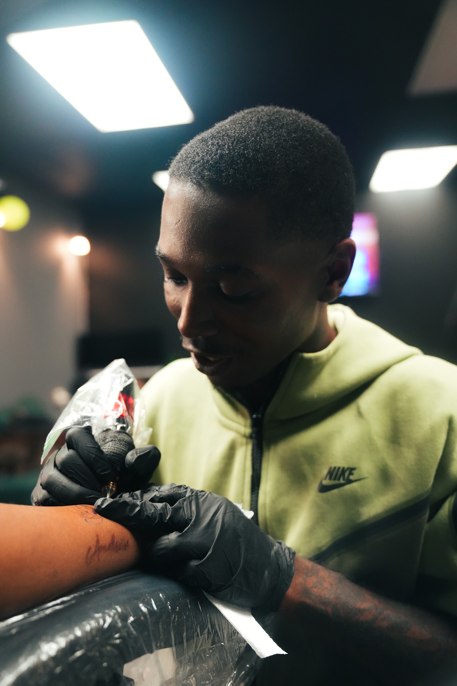 OFFWRLD.INK artist tattooing a client